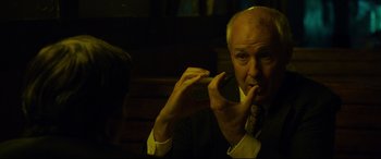 Movie still from “Dark Waters” (2019), directed by Todd Haynes – An older man in a suit and tie holding a cigarette; Close Up shot, Over the shoulder angle