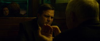 Movie still from “Dark Waters” (2019), directed by Todd Haynes – A man sitting in front of another man in front of a wooden wall; Close Up shot, Over the shoulder angle