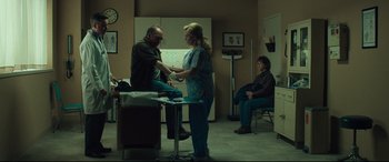 Movie still from “Dark Waters” (2019), directed by Todd Haynes – A man and a woman are sitting in a room; Wide shot, Over the shoulder angle