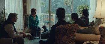 Movie still from “Dark Waters” (2019), directed by Todd Haynes – A group of people sitting in a living room; Wide shot, Over the shoulder angle