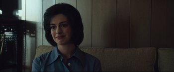 Movie still from “Dark Waters” (2019), directed by Todd Haynes – A woman sitting on a couch in front of a wooden wall; Close Up shot, Over the shoulder angle