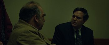 Movie still from “Dark Waters” (2019), directed by Todd Haynes – Two men in business suits are talking to each other; Close Up shot, Over the shoulder angle