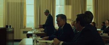 Movie still from “Dark Waters” (2019), directed by Todd Haynes – A group of people sitting around a table; Medium shot, Over the shoulder angle