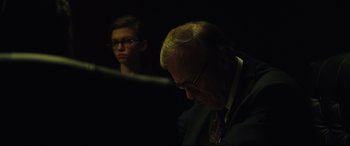 Movie still from “Dark Waters” (2019), directed by Todd Haynes – A man and a woman in a dark room; Medium shot, Over the shoulder angle