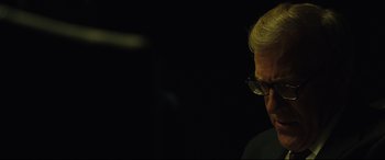 Movie still from “Dark Waters” (2019), directed by Todd Haynes – A man with glasses is looking at the camera; Close Up shot, Over the shoulder angle
