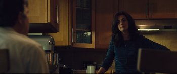 Movie still from “Dark Waters” (2019), directed by Todd Haynes – A woman standing in a kitchen next to a coffee pot; Medium shot, Over the shoulder angle