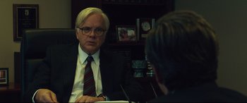 Movie still from “Dark Waters” (2019), directed by Todd Haynes – A man sitting at a table in front of another man; Close Up shot, Over the shoulder angle