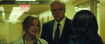 Movie still from “Dark Waters” (2019), directed by Todd Haynes – A man and a woman standing next to each other in a hallway; Medium shot, Over the shoulder angle