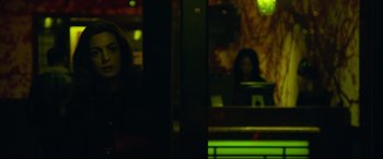 Movie still from “Dark Waters” (2019), directed by Todd Haynes – A woman sitting at a table in front of a laptop; Medium shot, Over the shoulder angle