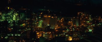 Movie still from “Dark Waters” (2019), directed by Todd Haynes – A city lit up at night with lots of lights; Extreme Wide shot, High angle