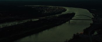 Movie still from “Dark Waters” (2019), directed by Todd Haynes – A view of a city at night from a plane window; Extreme Wide shot, High angle