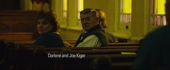 Movie still from “Dark Waters” (2019), directed by Todd Haynes – A man sitting in a pew in a church; Medium shot, High angle