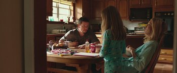 Movie still from “Deepwater Horizon” (2016), directed by Peter Berg – A man and a little girl sitting at a kitchen table; Medium shot, Over the shoulder angle