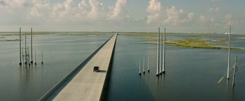 Movie still from “Deepwater Horizon” (2016), directed by Peter Berg – An aerial view of a bridge over a body of water; Extreme Wide shot, High angle