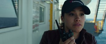 Movie still from “Deepwater Horizon” (2016), directed by Peter Berg – A woman wearing a baseball cap holding a walkie talkie; Close Up shot, Over the shoulder angle