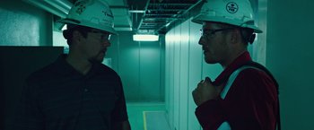Movie still from “Deepwater Horizon” (2016), directed by Peter Berg – Two men in hard hats are talking in a building; Close Up shot, Low angle