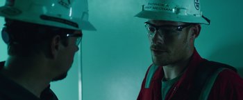 Movie still from “Deepwater Horizon” (2016), directed by Peter Berg – A man in a red shirt and a man in a white hat; Close Up shot, Over the shoulder angle