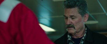 Movie still from “Deepwater Horizon” (2016), directed by Peter Berg – An older man with a beard and a mustache; Close Up shot, Over the shoulder angle