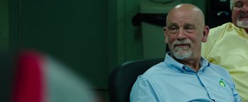 Movie still from “Deepwater Horizon” (2016), directed by Peter Berg – An older man wearing a blue shirt sitting in an office chair; Close Up shot, Over the shoulder angle