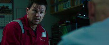 Movie still from “Deepwater Horizon” (2016), directed by Peter Berg – A person wearing a red shirt; Close Up shot, Over the shoulder angle