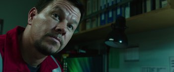 Movie still from “Deepwater Horizon” (2016), directed by Peter Berg – A man's face in front of a television; Close Up shot, Low angle