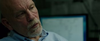 Movie still from “Deepwater Horizon” (2016), directed by Peter Berg – An old man with a beard is sitting in a chair; Close Up shot, Over the shoulder angle