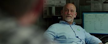Movie still from “Deepwater Horizon” (2016), directed by Peter Berg – An older man sitting in front of a coffee maker; Close Up shot, Over the shoulder angle