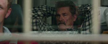 Movie still from “Deepwater Horizon” (2016), directed by Peter Berg – An older man sitting in front of a window; Close Up shot, High angle