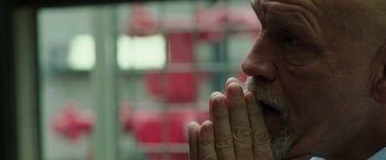 Movie still from “Deepwater Horizon” (2016), directed by Peter Berg – A man's face with his hands clasped in prayer; Close Up shot, Low angle