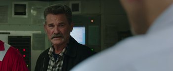 Movie still from “Deepwater Horizon” (2016), directed by Peter Berg – An older man with a mustache is looking at the camera; Close Up shot, Over the shoulder angle