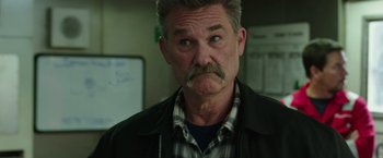 Movie still from “Deepwater Horizon” (2016), directed by Peter Berg – A person with a mustache; Close Up shot, Over the shoulder angle