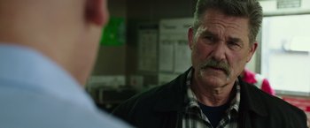 Movie still from “Deepwater Horizon” (2016), directed by Peter Berg – An older man with a mustache talking to another man; Close Up shot, Over the shoulder angle