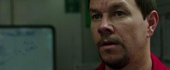 Movie still from “Deepwater Horizon” (2016), directed by Peter Berg – A person with a beard; Close Up shot, Over the shoulder angle
