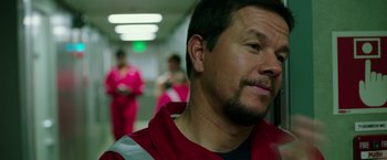 Movie still from “Deepwater Horizon” (2016), directed by Peter Berg – A person wearing a red shirt; Close Up shot, Over the shoulder angle