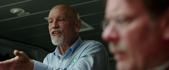Movie still from “Deepwater Horizon” (2016), directed by Peter Berg – An older man with a shaved head talking to another older man; Close Up shot, Over the shoulder angle