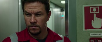 Movie still from “Deepwater Horizon” (2016), directed by Peter Berg – A person wearing a red shirt; Close Up shot, Over the shoulder angle