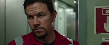 Movie still from “Deepwater Horizon” (2016), directed by Peter Berg – A person wearing a red and white shirt; Close Up shot, Over the shoulder angle
