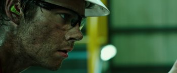 Movie still from “Deepwater Horizon” (2016), directed by Peter Berg – A person wearing glasses and a hard hat; Extreme Close Up shot, Low angle