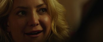 Movie still from “Deepwater Horizon” (2016), directed by Peter Berg – A woman's face with blonde hair and green eyes; Close Up shot, Over the shoulder angle