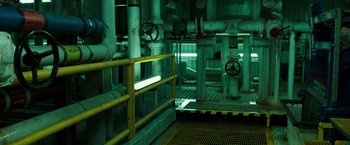 Movie still from “Deepwater Horizon” (2016), directed by Peter Berg – A view of pipes and a fire hydrant in a building; Extreme Wide shot, High angle