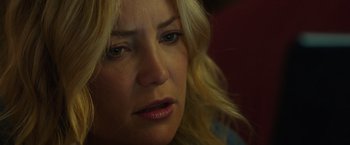 Movie still from “Deepwater Horizon” (2016), directed by Peter Berg – A woman's face in a dimly - lit room; Close Up shot, Over the shoulder angle