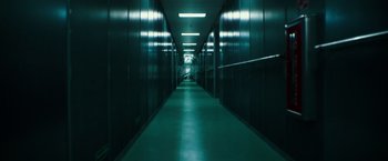 Movie still from “Deepwater Horizon” (2016), directed by Peter Berg – A long hallway in a building with a green floor; Extreme Wide shot, Low angle