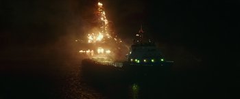 Movie still from “Deepwater Horizon” (2016), directed by Peter Berg – A large boat in the water at night with lights on; Extreme Wide shot, High angle