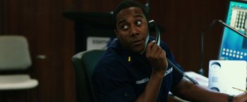 Movie still from “Deepwater Horizon” (2016), directed by Peter Berg – A man sitting in a chair holding a phone to his ear; Close Up shot, High angle