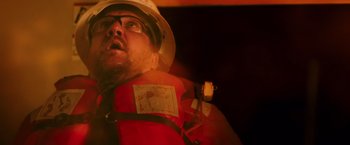 Movie still from “Deepwater Horizon” (2016), directed by Peter Berg – A person wearing a life jacket; Close Up shot, Low angle