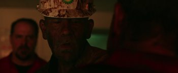 Movie still from “Deepwater Horizon” (2016), directed by Peter Berg – An older man wearing a hat and a camouflage hat; Close Up shot, High angle