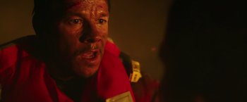 Movie still from “Deepwater Horizon” (2016), directed by Peter Berg – A person wearing a life jacket; Close Up shot, Over the shoulder angle