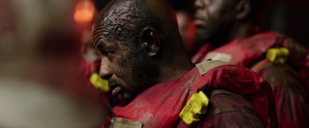 Movie still from “Deepwater Horizon” (2016), directed by Peter Berg – A person wearing a red uniform; Close Up shot, Over the shoulder angle
