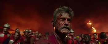 Movie still from “Deepwater Horizon” (2016), directed by Peter Berg – A group of men in red shirts with blood on their faces; Close Up shot, Low angle