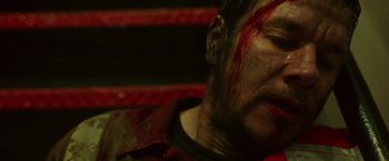Movie still from “Deepwater Horizon” (2016), directed by Peter Berg – A person with blood all over his face; Close Up shot, High angle